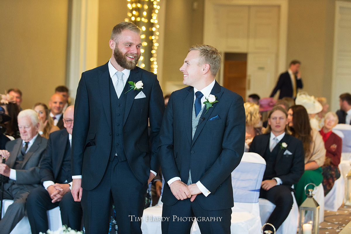 groom and best man just before the bride comes down the aisle